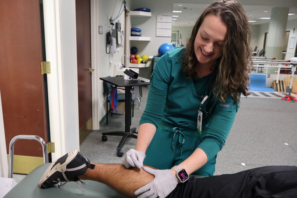 St. Joseph's/Candler Physical Therapist Ansley Rodriguez practicing dry needle therapy on a patient