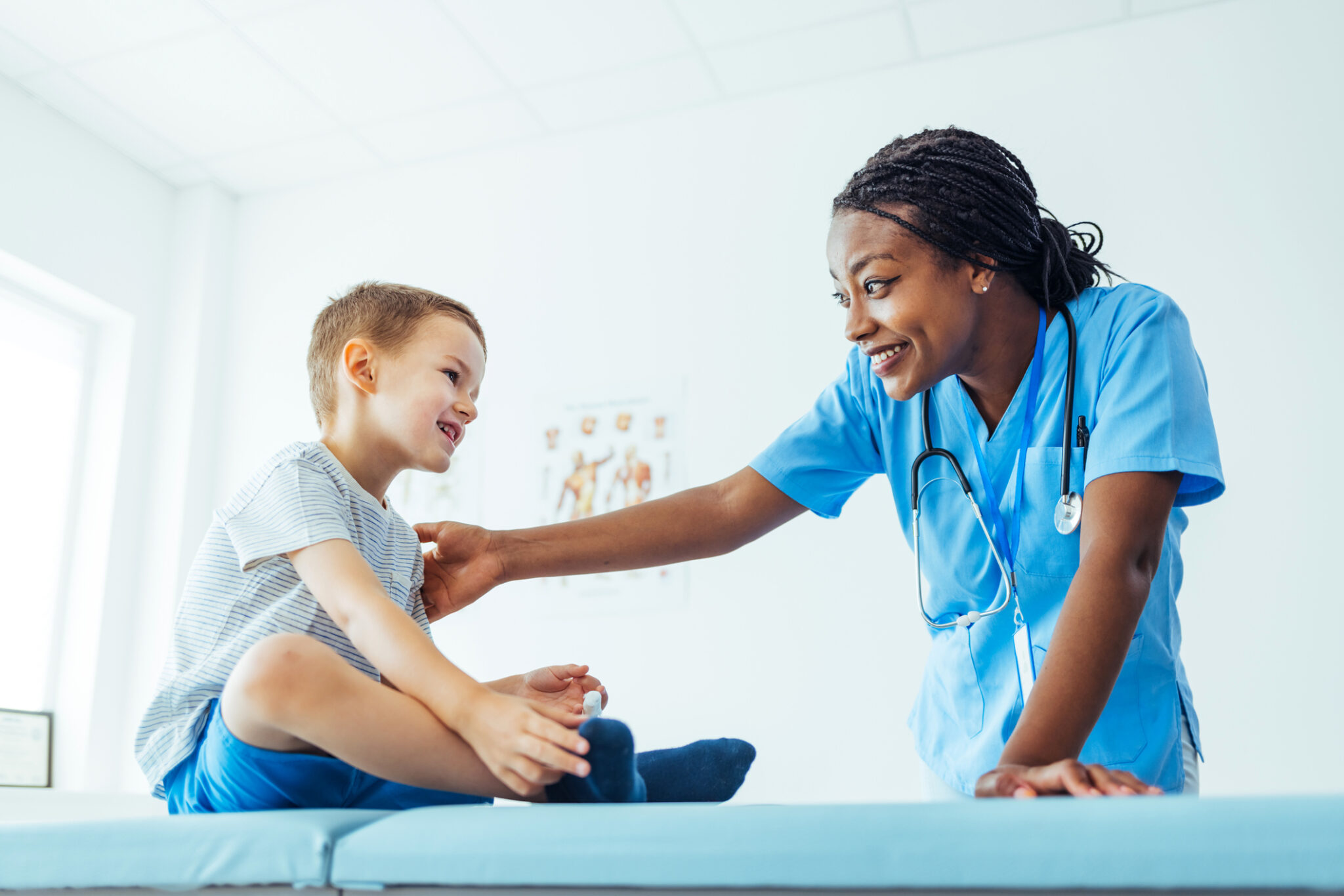 female doctor helping a small boy