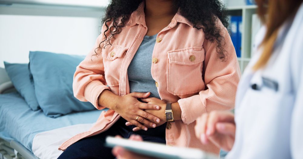 Woman with doctor holding her stomach