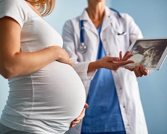 Pregnant female with doctor