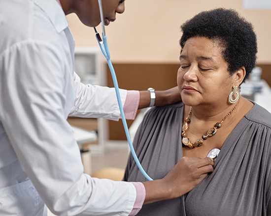 Adult female getting her heart beat listened to