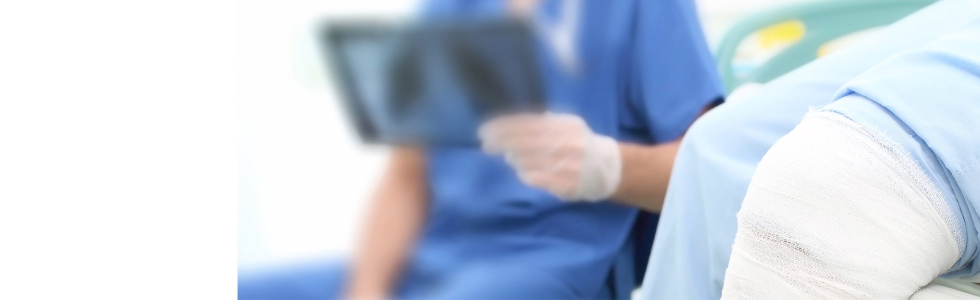 healthcare provider looking at xray of patient's knee